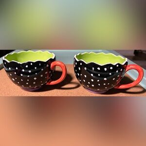 These are a set of Department 56 black and white polka dot tea coffee mugs.